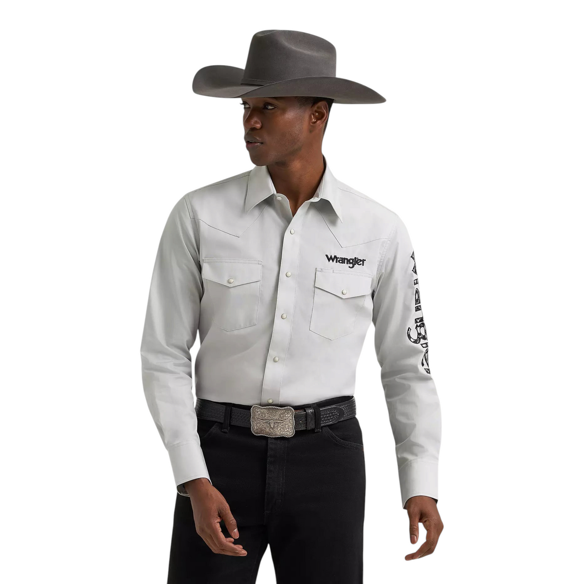Model wearing a light grey Wrangler long sleeve Western snap shirt with logo details from Cowboy City Western Wear