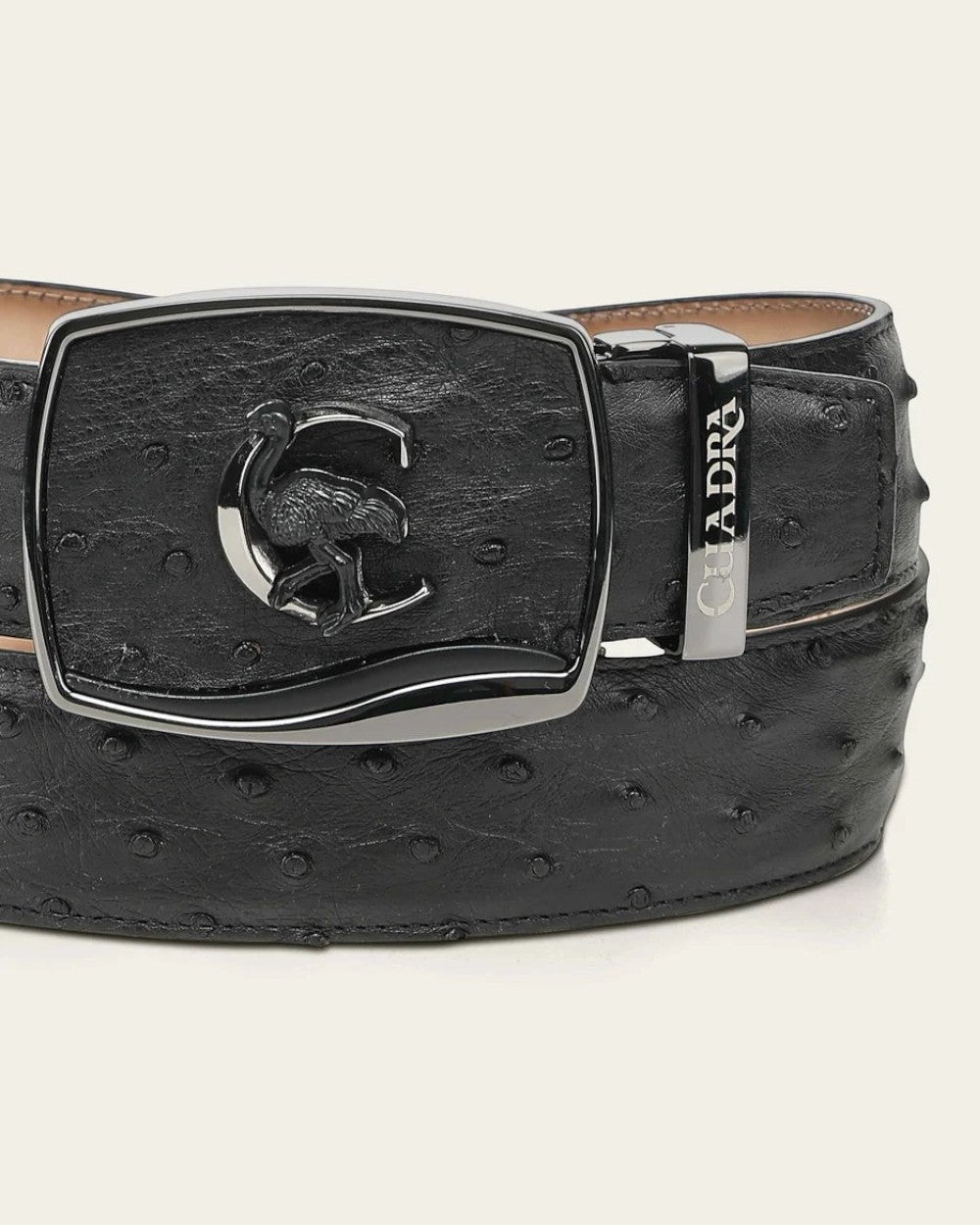 Cowboy City Western Wear black ostrich leather belt with a retractable buckle featuring a Cuadra monogram and emblem.